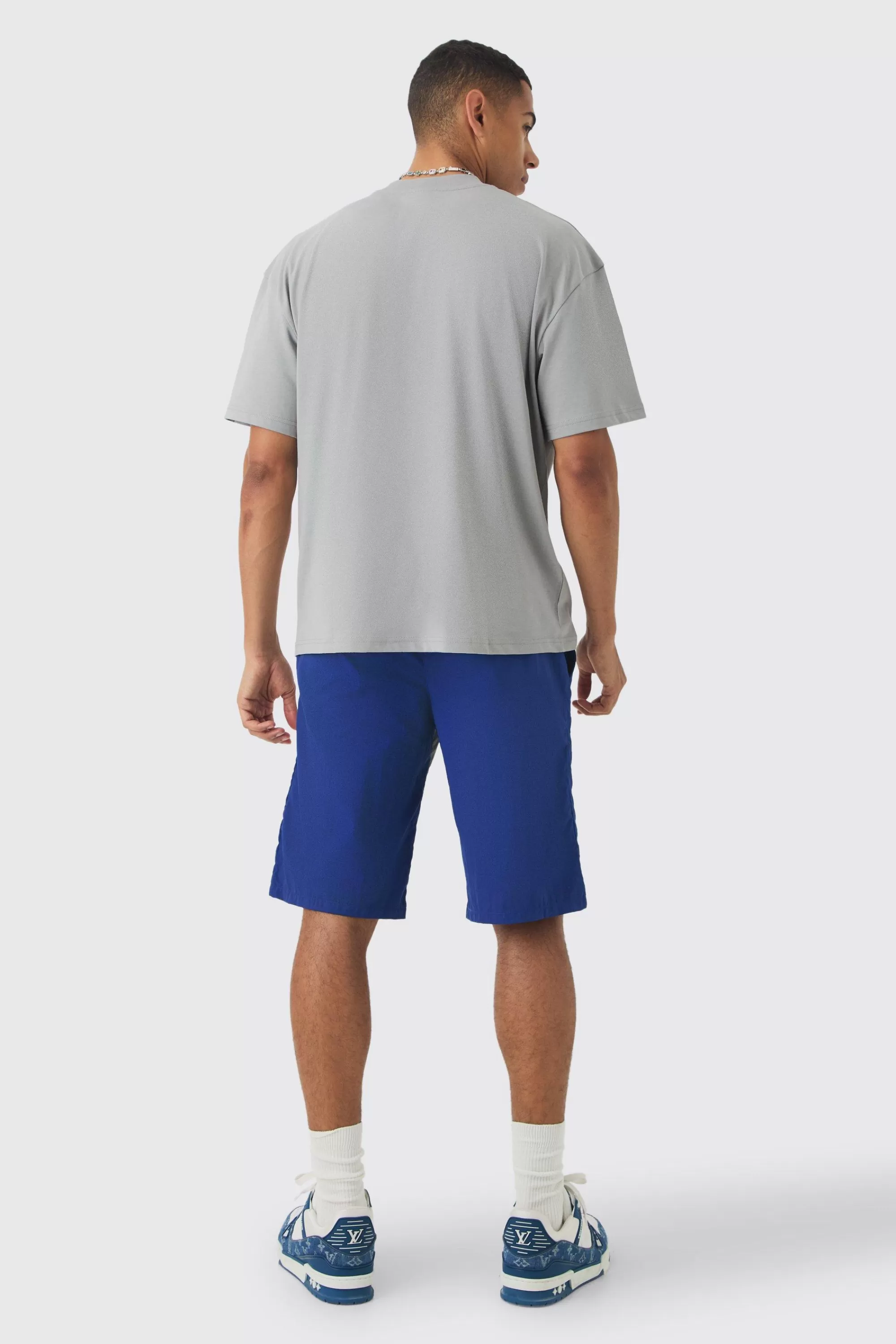 boohooMAN Elasticated Waist Limited Relaxed Longline Shell Panel Shorts | UK