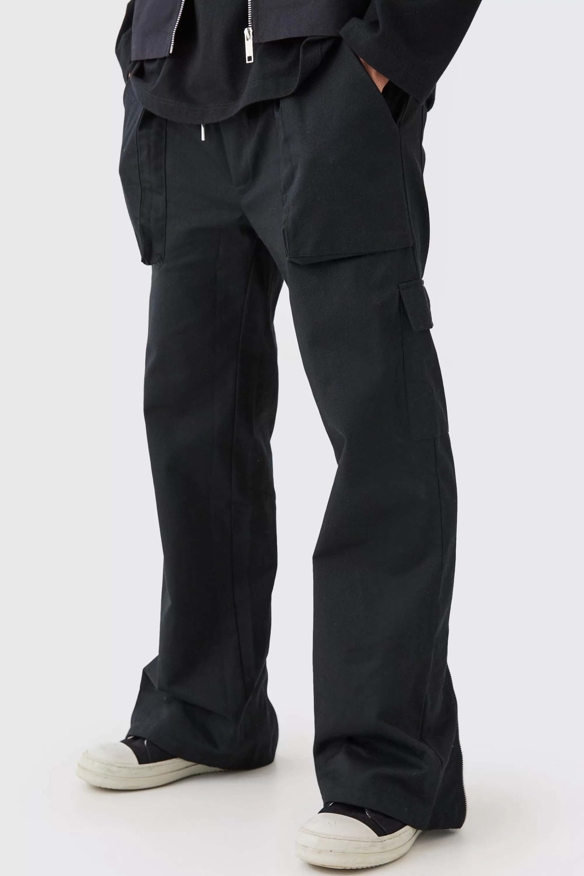 boohooMAN Elasticated Waist Zip Hem Flared Cargo Trousers | UK