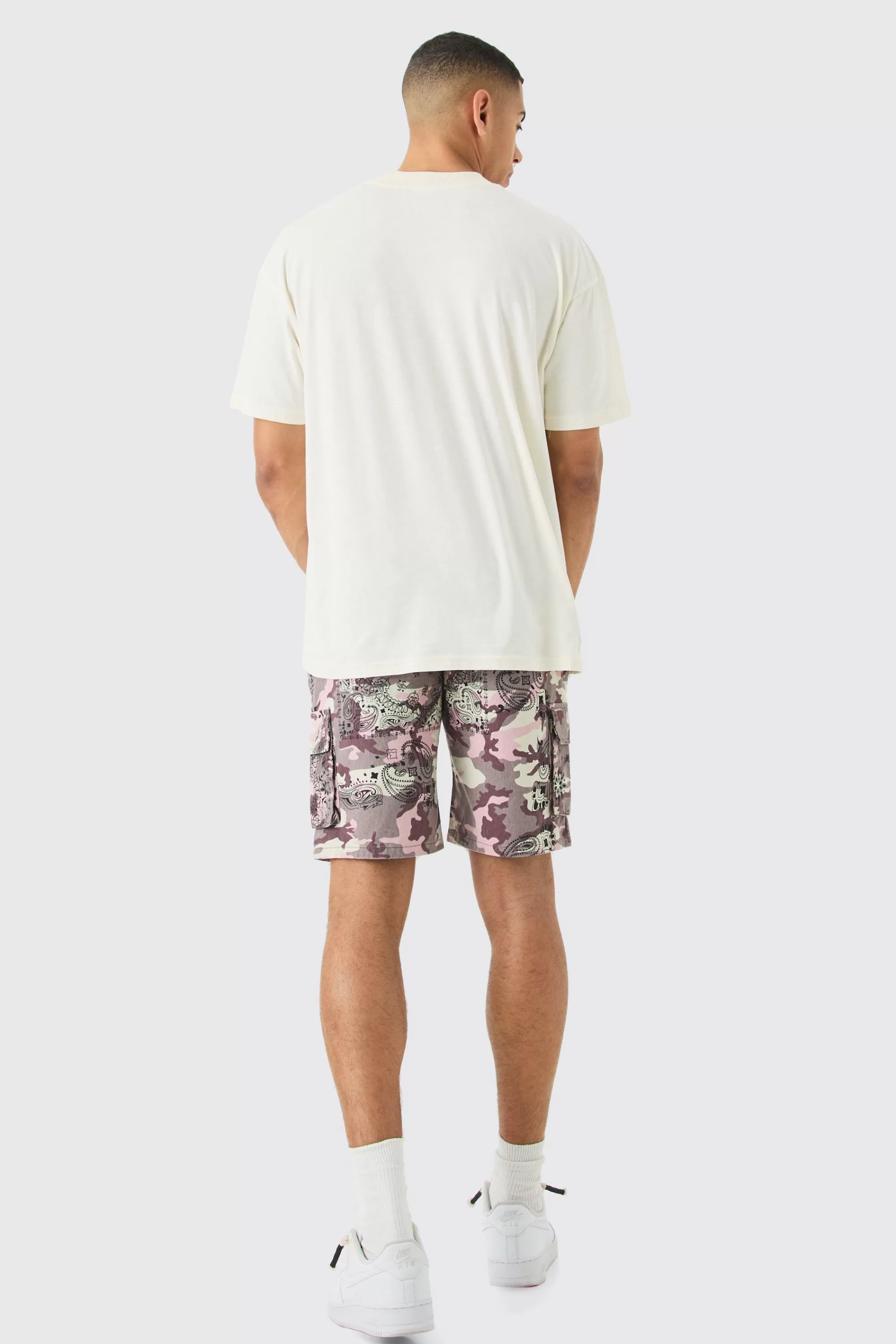 boohooMAN Fixed Waist Woven Tab Bandanna Camo Relaxed Cargo Shorts | UK