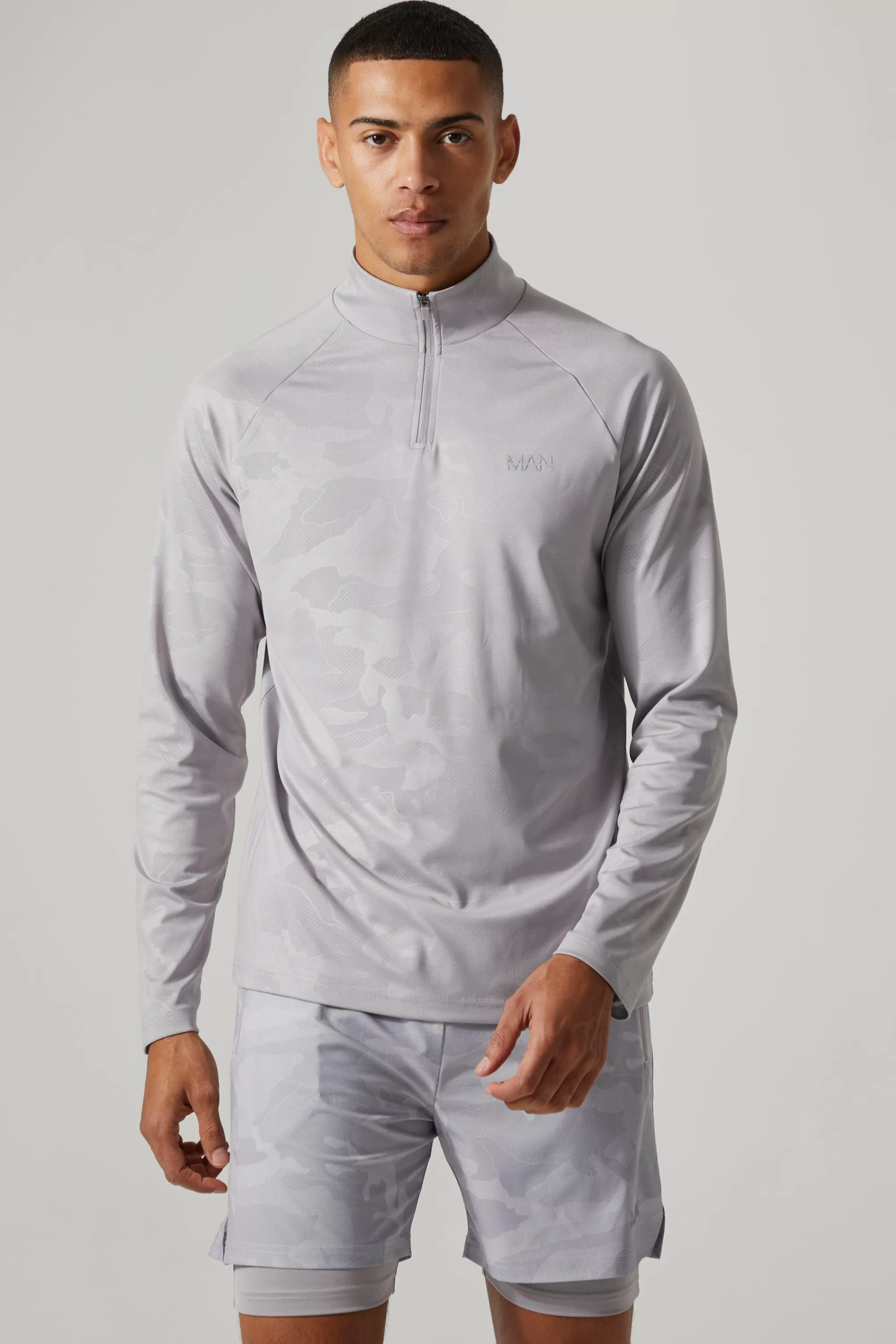 boohooMAN Man Active Camo Print Regular Fit 1/4 Zip Top | UK