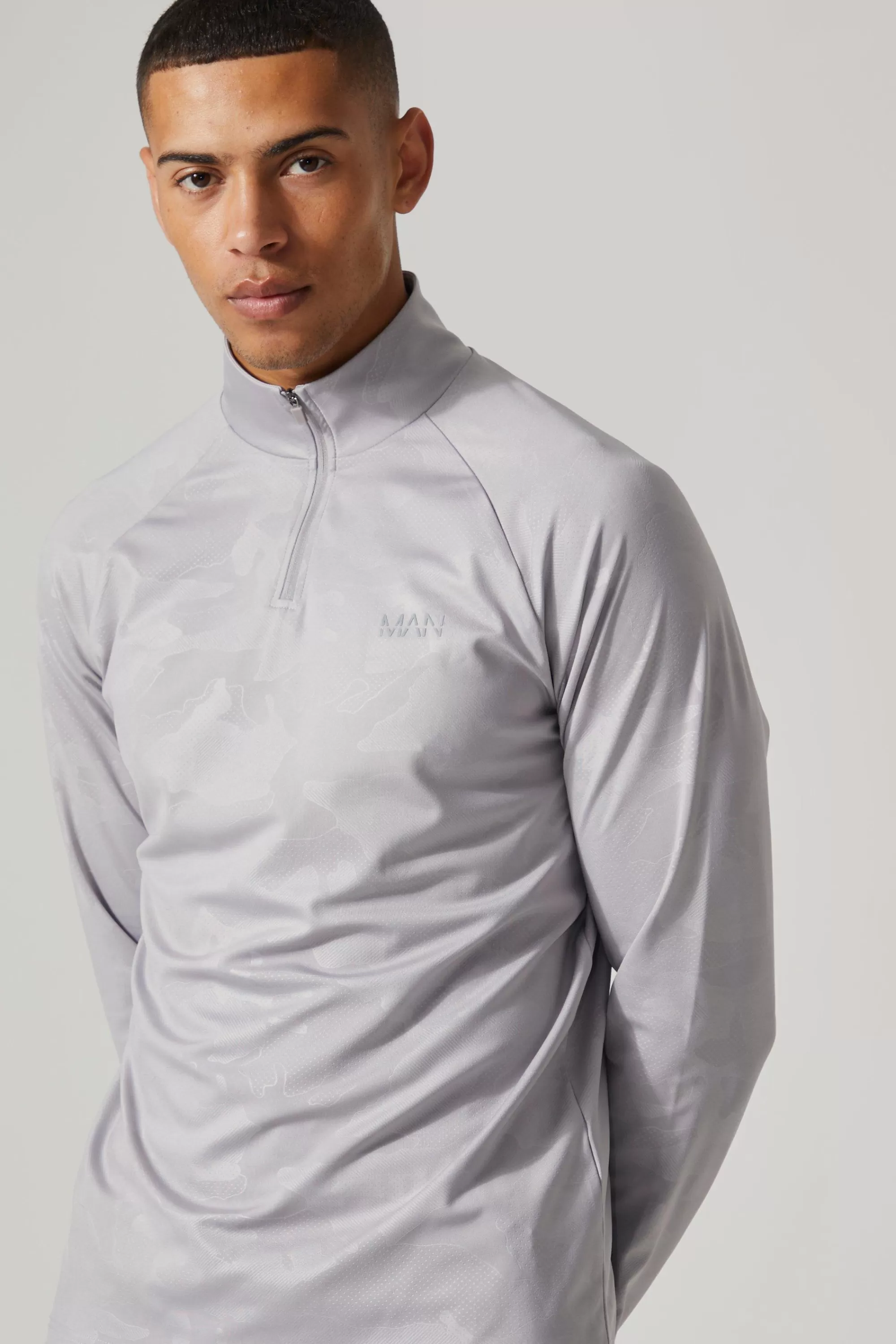 boohooMAN Man Active Camo Print Regular Fit 1/4 Zip Top | UK