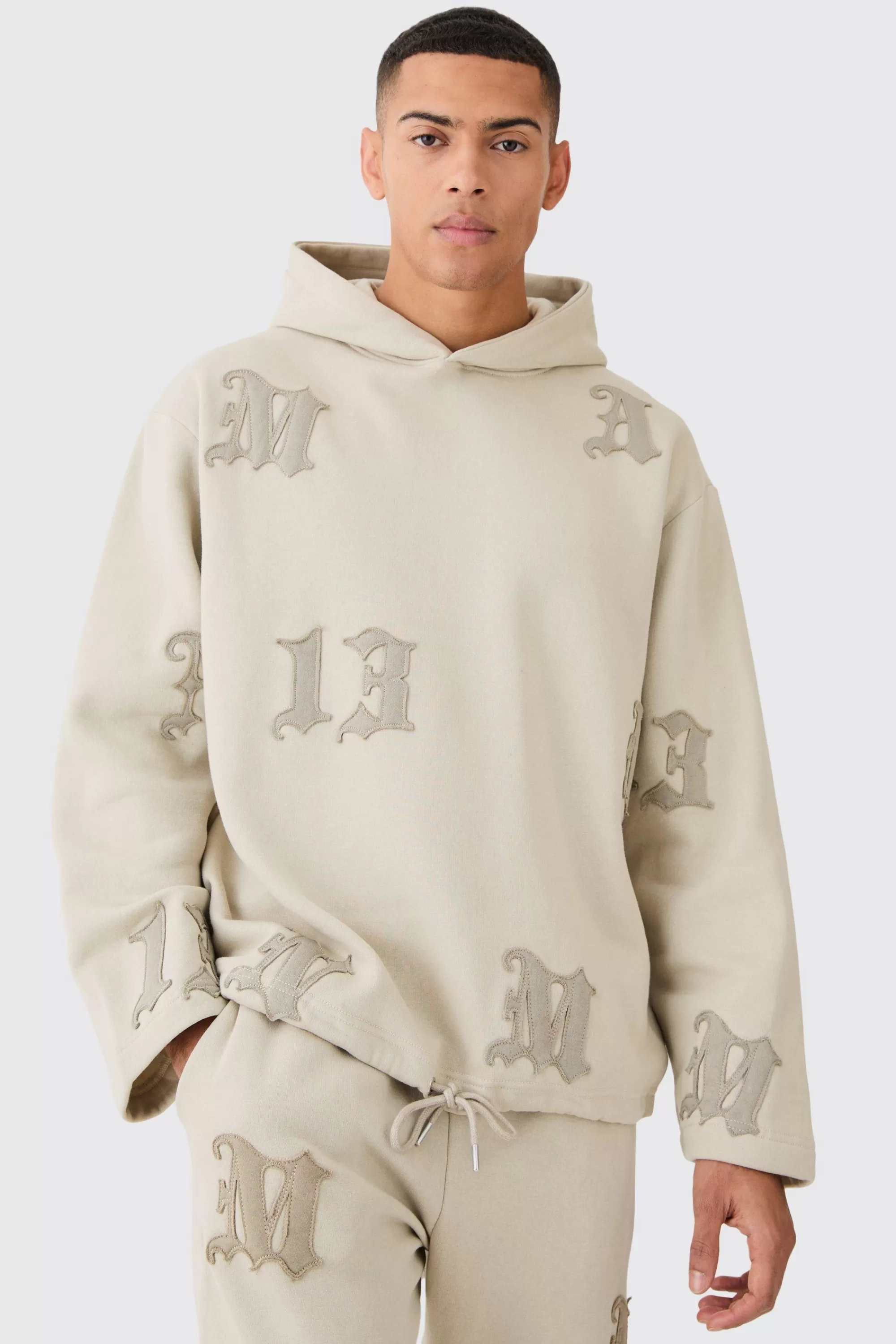 boohooMAN Oversized All Over Applique Open Hem Hoodie | UK