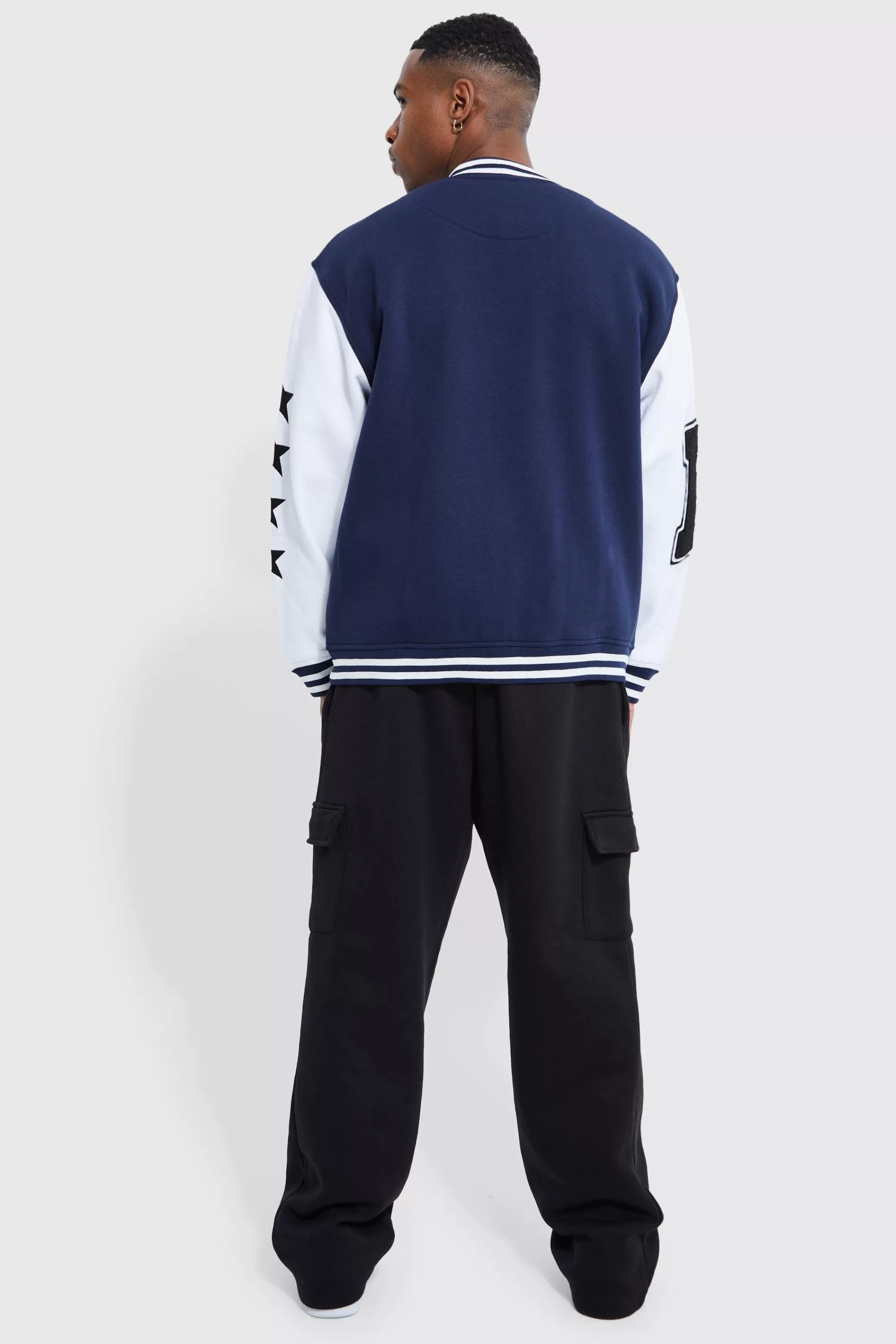 boohooMAN Oversized Badge Jersey Varsity Jacket | UK