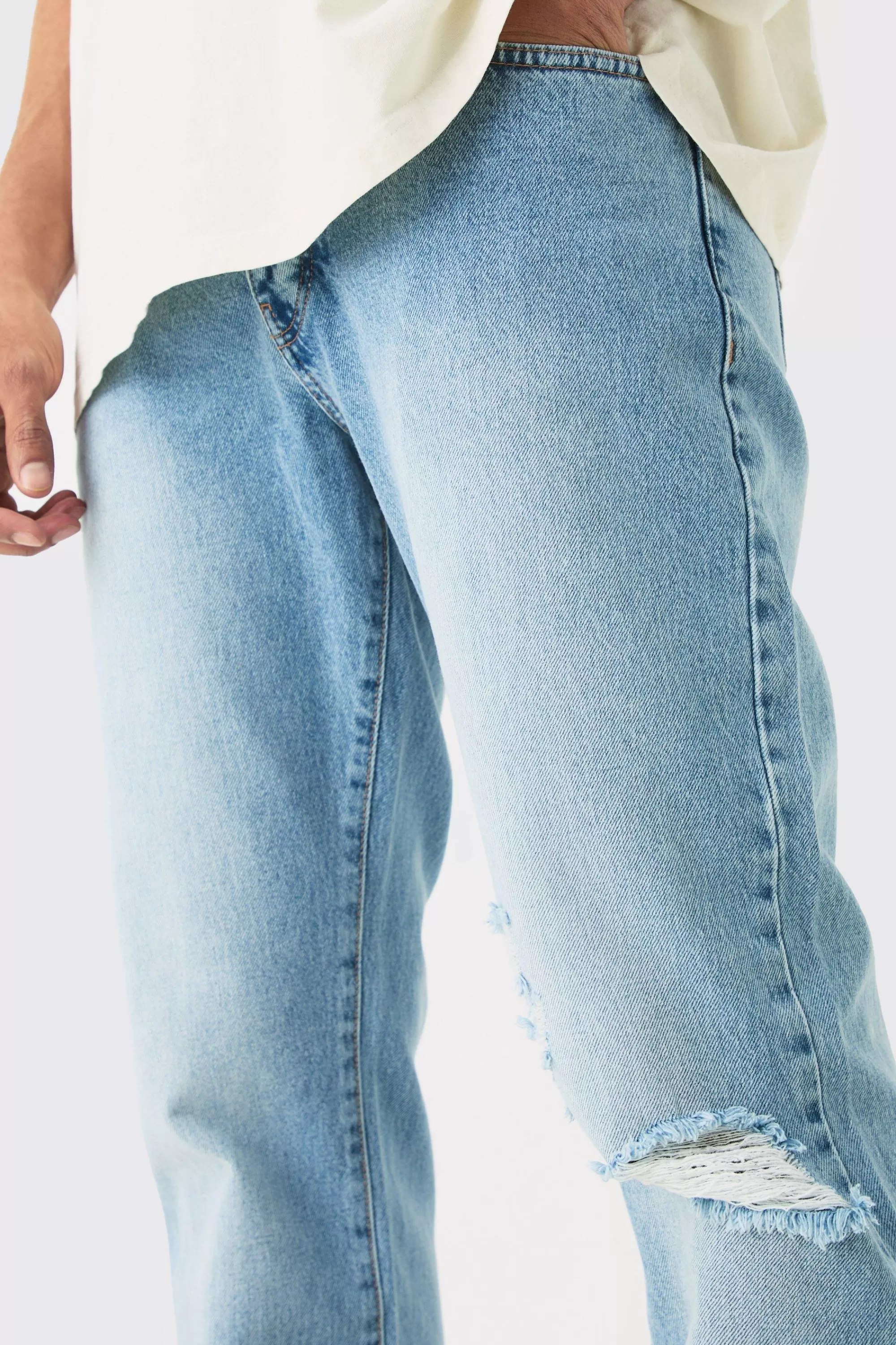 boohooMAN Relaxed Flare Rigid Knee Rip Snow Wash Denim Jean | UK