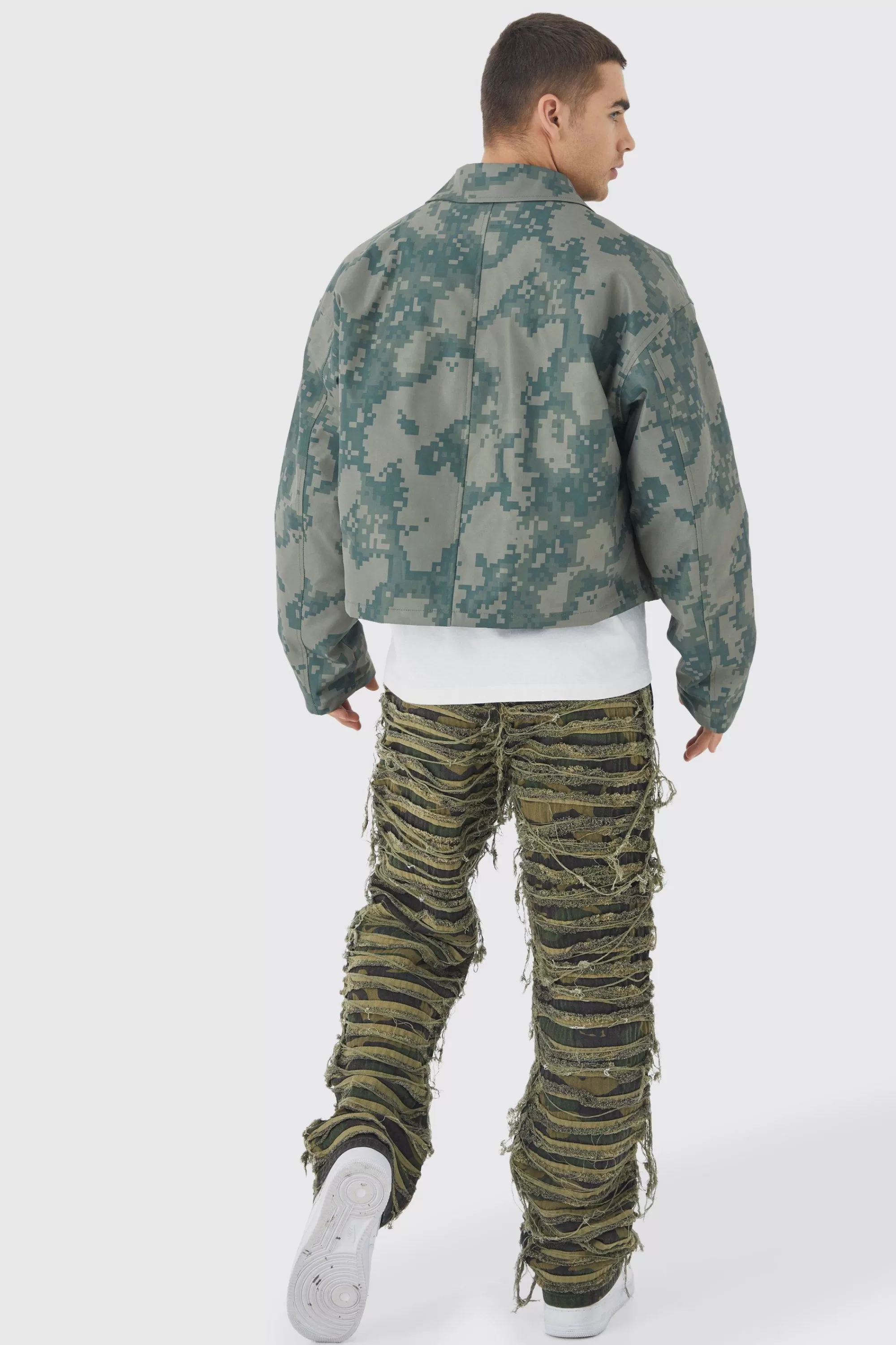 boohooMAN Relaxed Heavily Distressed Camo Trouser | UK