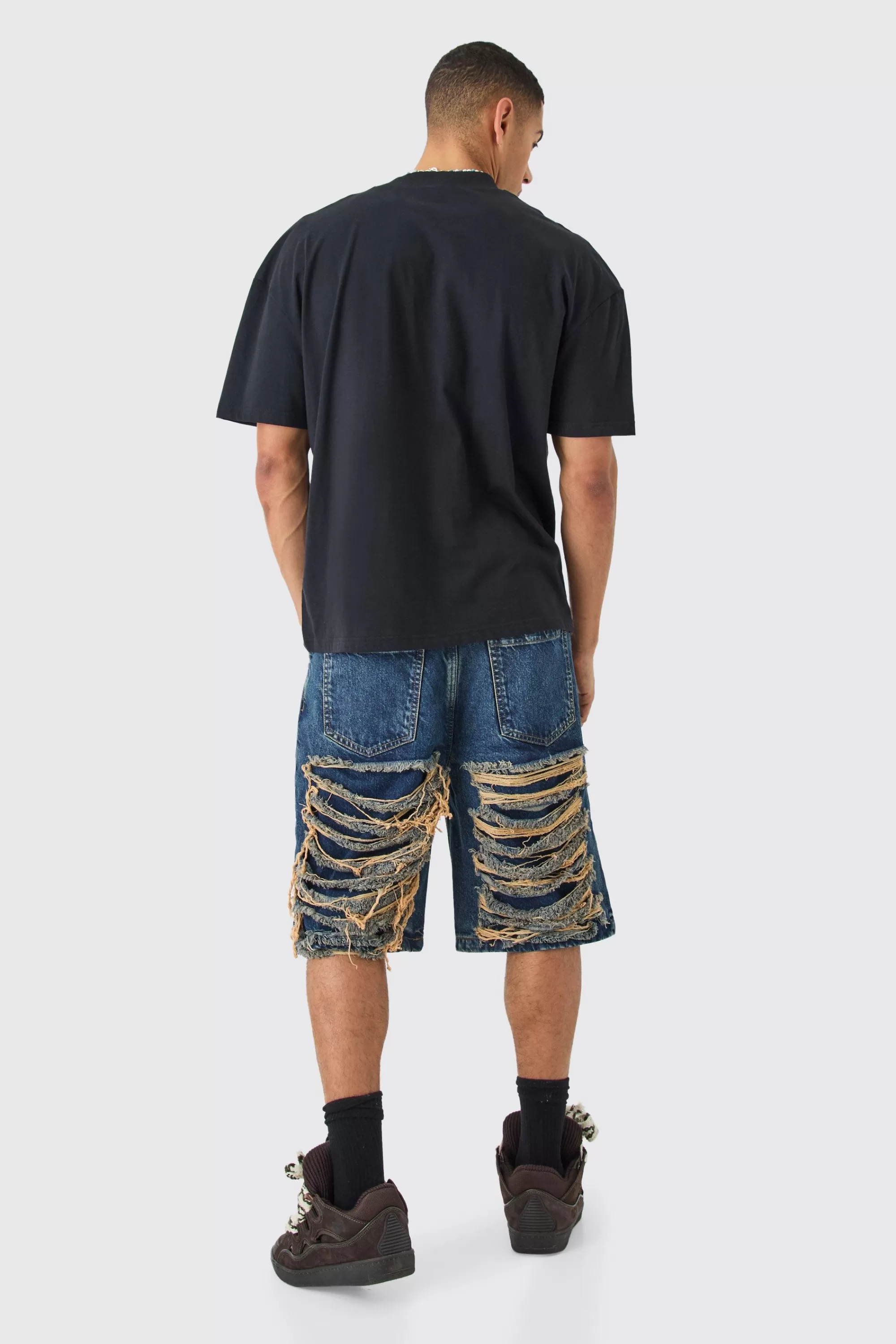 boohooMAN Relaxed Rigid Extreme Ripped Denim Jorts In | UK