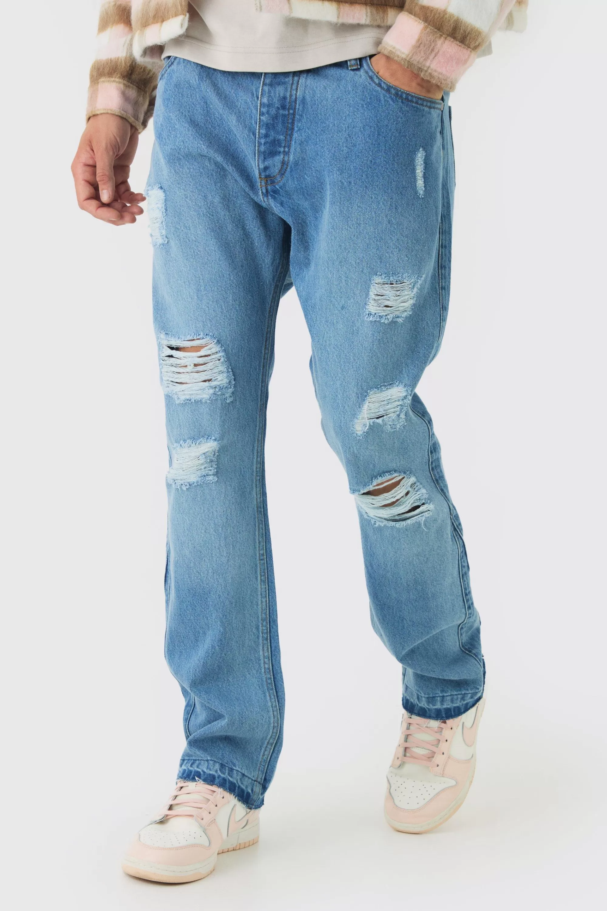 boohooMAN Slim Fit Flared Ripped Knee Jeans With Let Down Hem | UK