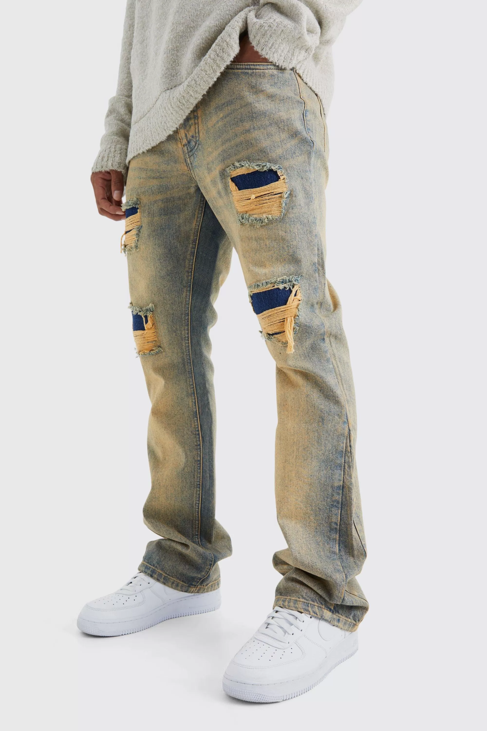 boohooMAN Slim Flare Rigid Multi Rip & Repair Jean | UK