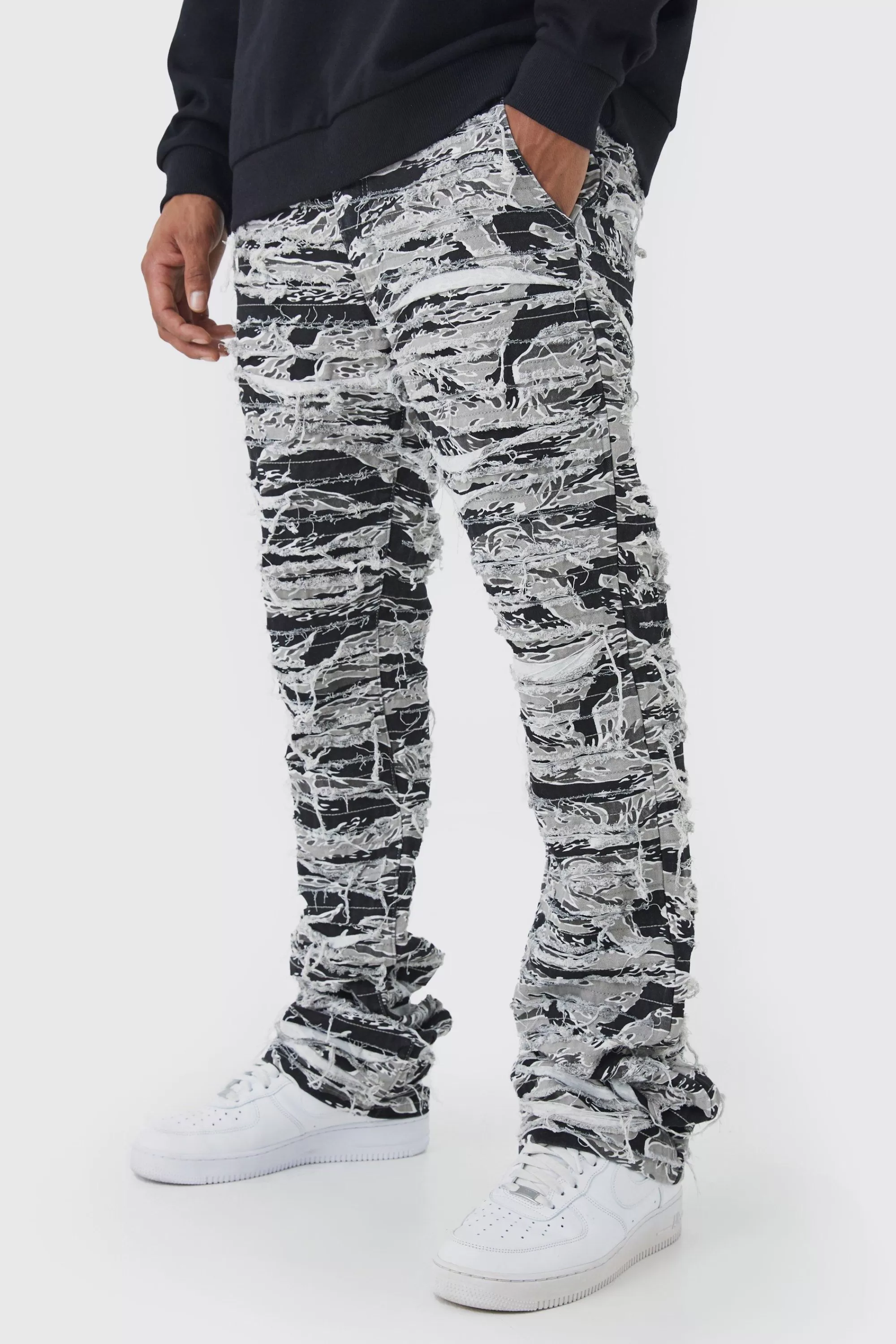 boohooMAN Slim Stacked Flare Heavily Distressed Camo Trouser | UK