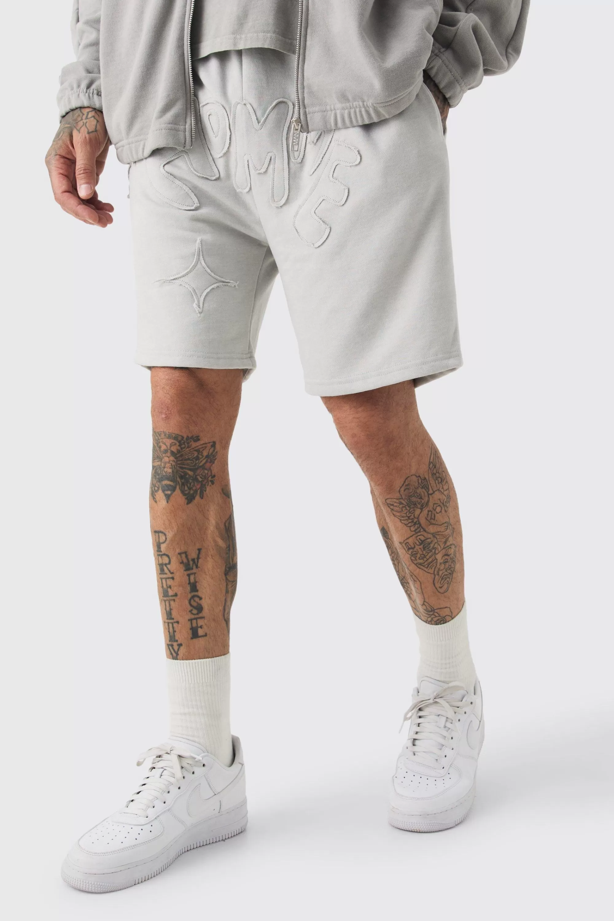 boohooMAN Tall Distressed Applique Loose Short In | UK