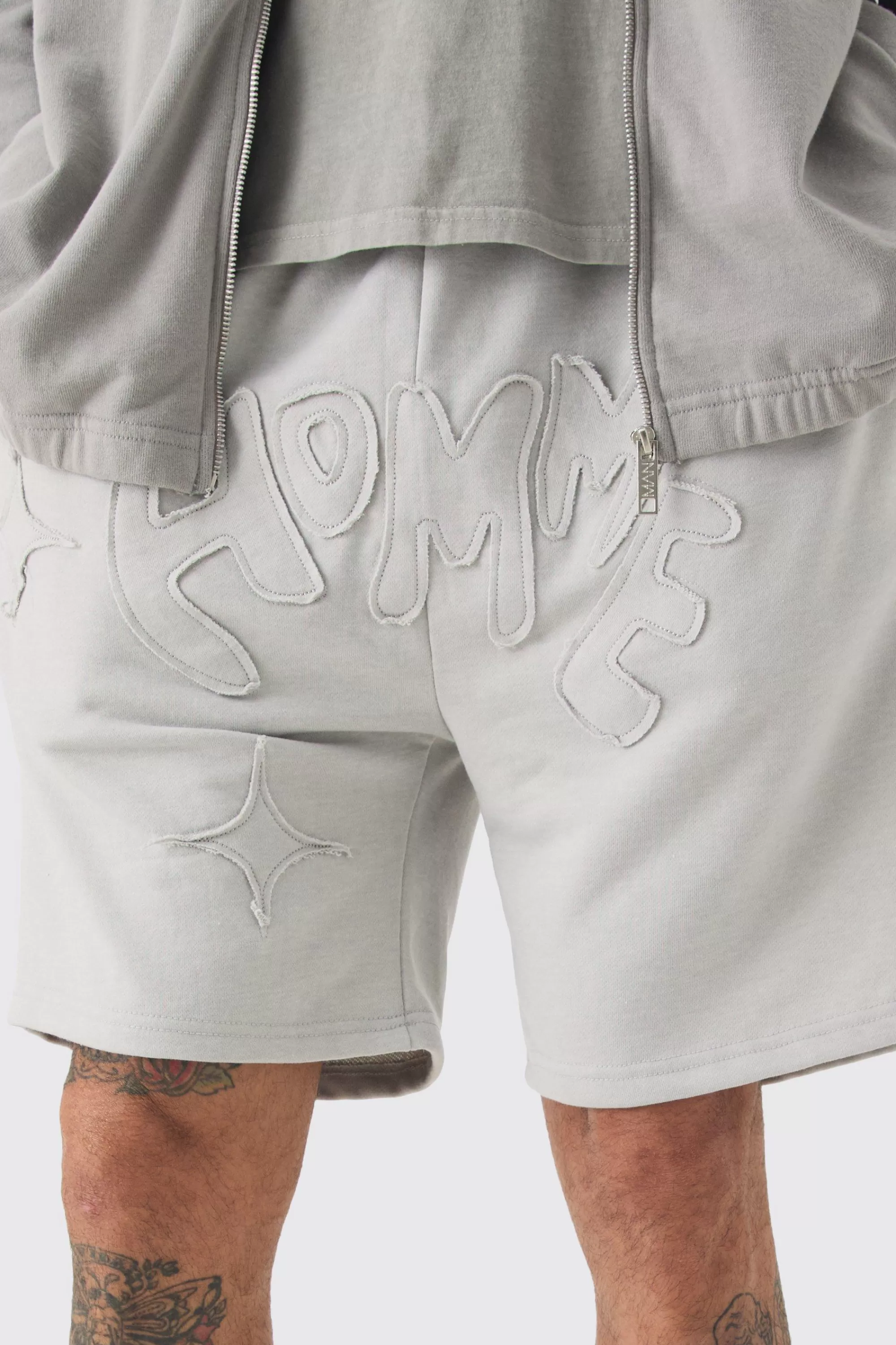 boohooMAN Tall Distressed Applique Loose Short In | UK