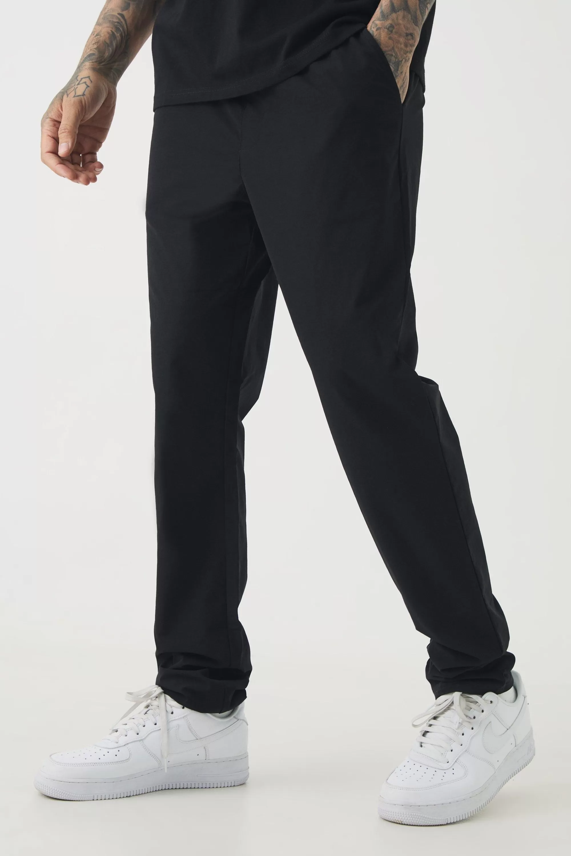 boohooMAN Tall Elasticated Waist Lightweight Technical Stretch Slim Trouser | UK