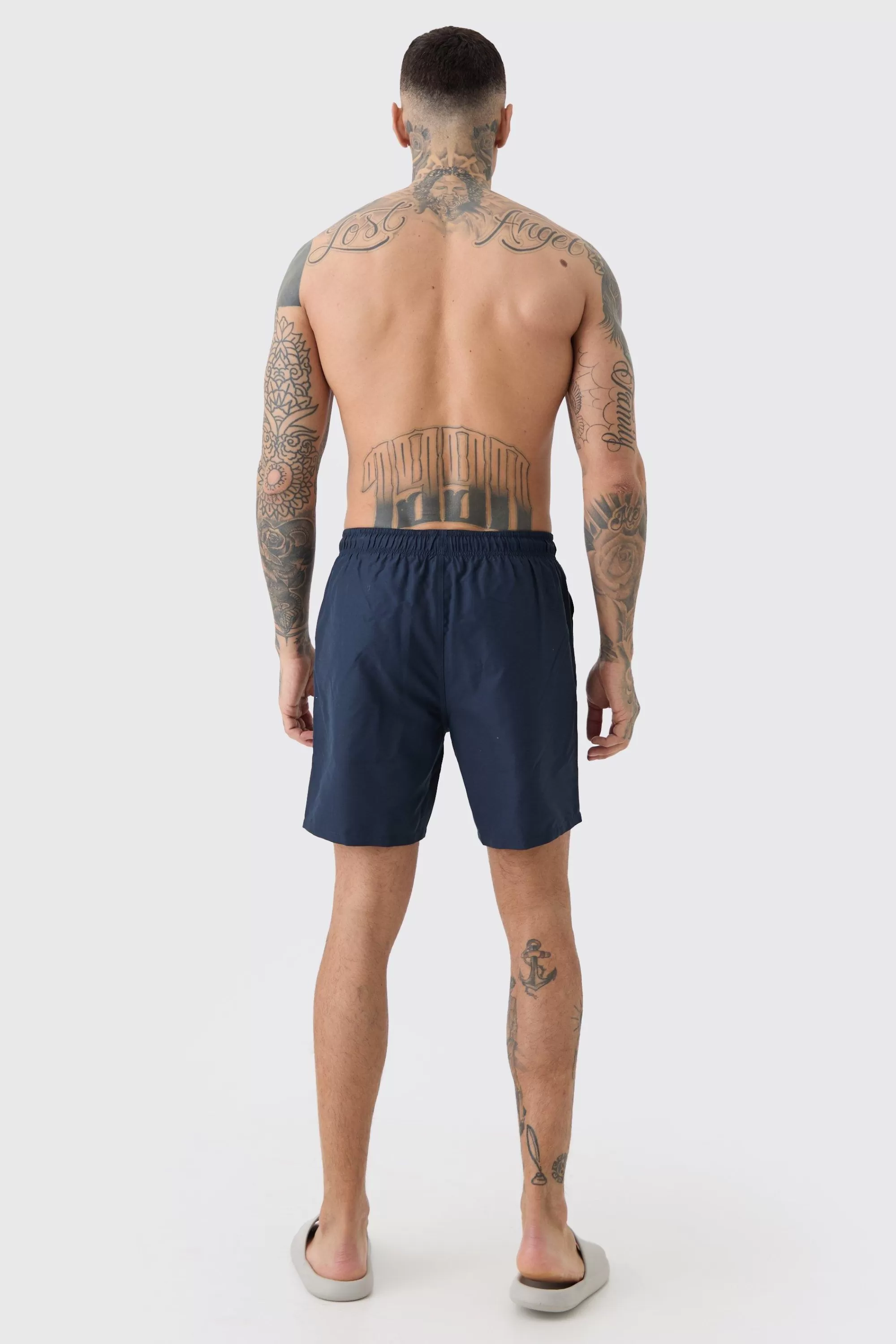 boohooMAN Tall Plain Mid Length Swim Short | UK